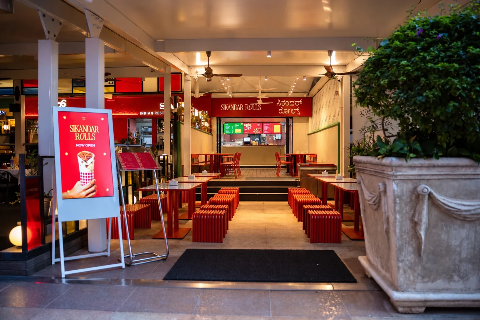 The Sikandar Rolls outlet at UB City, Bengaluru, with red seating under a white canopy